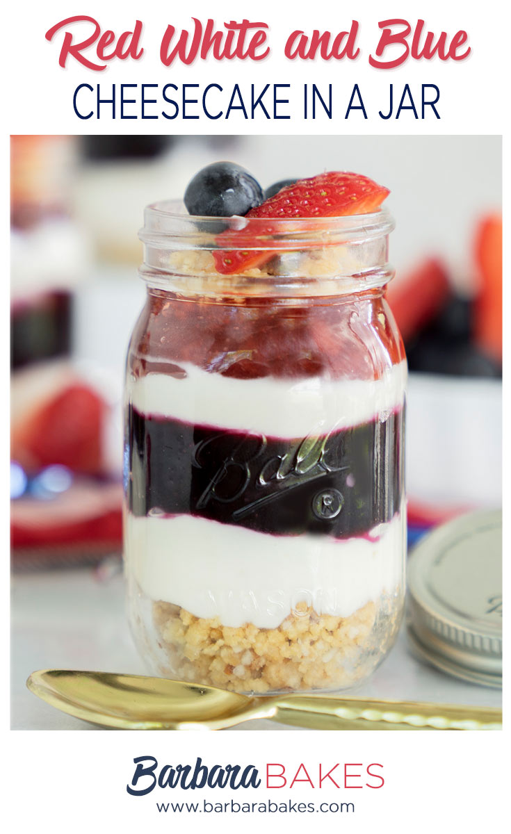 Red, white and blue cheesecake in a mason jar with fresh blueberry and strawberry compote, cream cheese filling and cookie crust