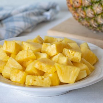 plate of pineapple cut into equal cubes