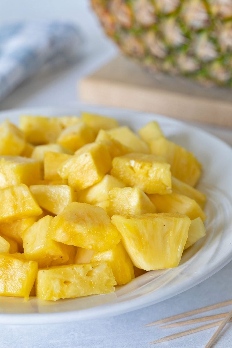 cubed pineapple cut without the skin on a white plate
