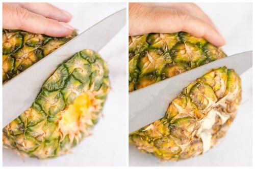 slicing the top and bottom off of a whole pineapple