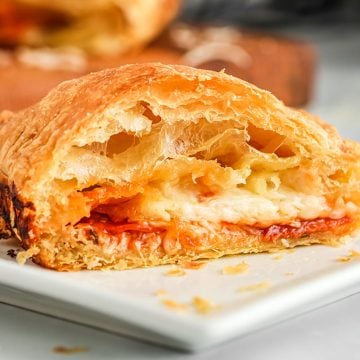 air fryer pizza pocket cut in half to show cheese, pepperoni and pizza sauce