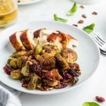 roasted Brussels sprouts on a plate with sliced turkey