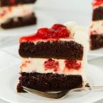 slice of black forest cheesecake cake with cherry pie filling