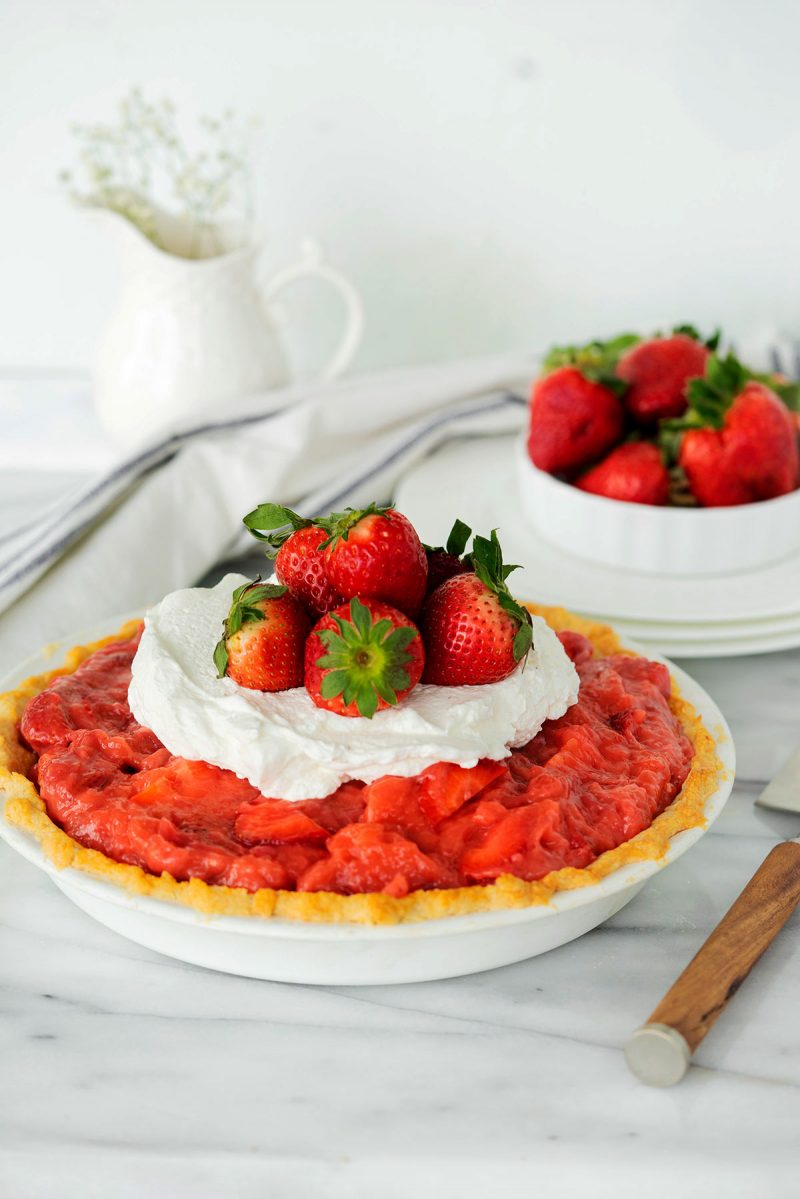 whole fresh strawberry pie with whipped cream on top