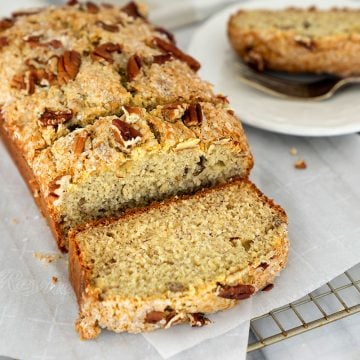 slices of easy banana bread with nuts on a wire rack