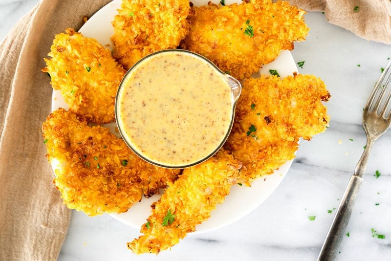 bowl of crispy chicken tenders with honey mustard dipping size