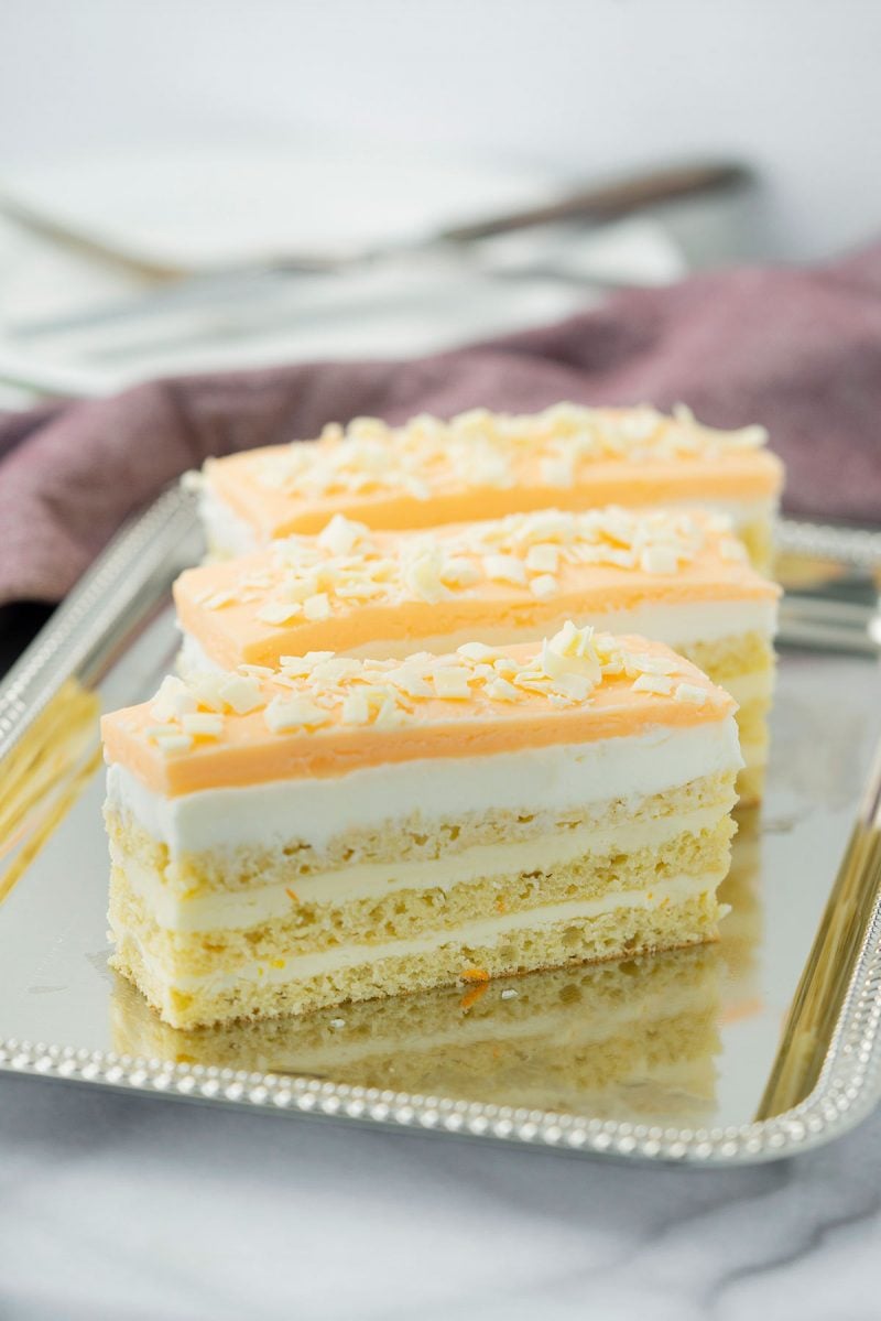 three slices of orange opera layer cake