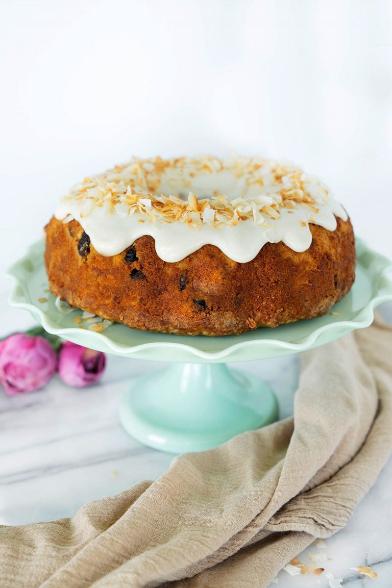 whole bundt cake with icing and toasted coconut
