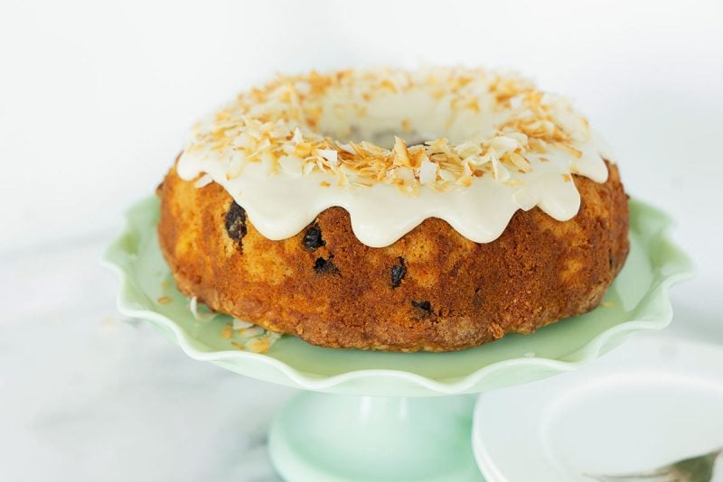 whole cake with cream cheese frosting and toasted coconut