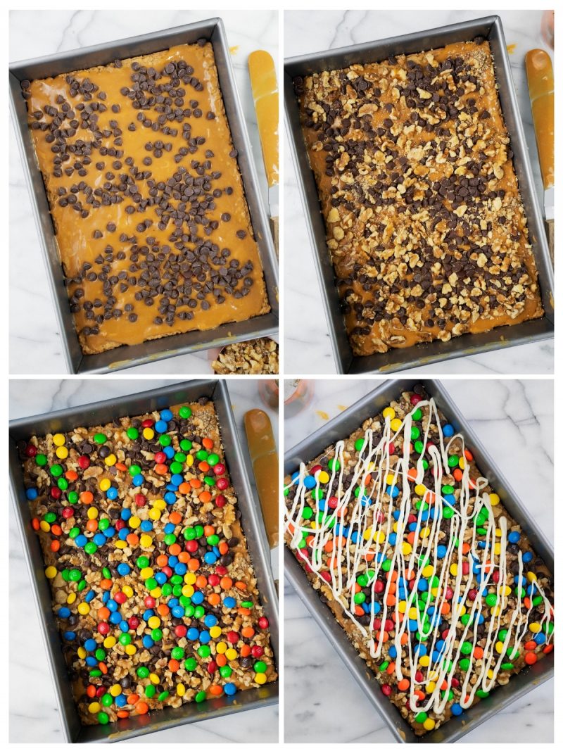 filling a pan with ingredients for oatmeal bars: M&m's, chocoalte chips, and white chocolate drizzle
