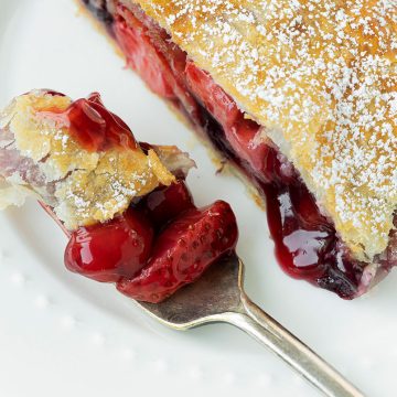 apple and berry strudel with a slice removed