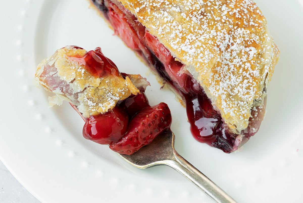apple and berry strudel with  a slice removed