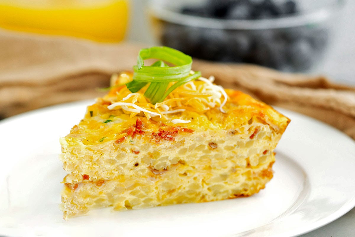 slice of hash brown quiche on a white plate