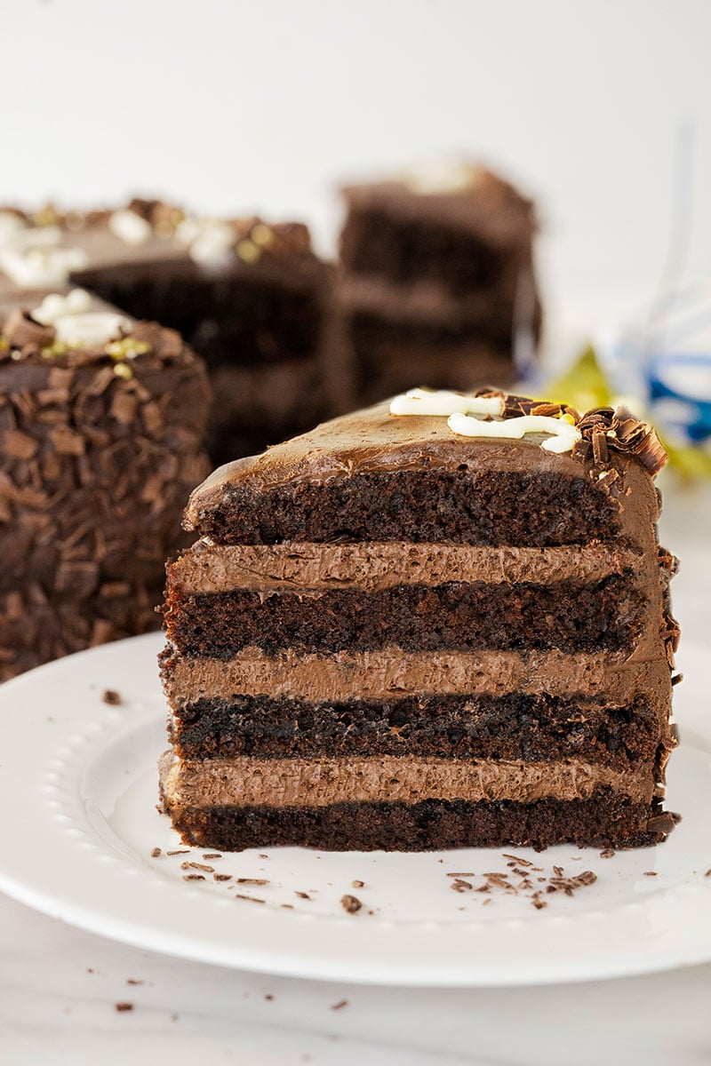 slice of four-layer chocolate cake with whipped buttercream