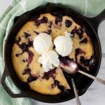 cherry cobbler with ice cream in a skillet
