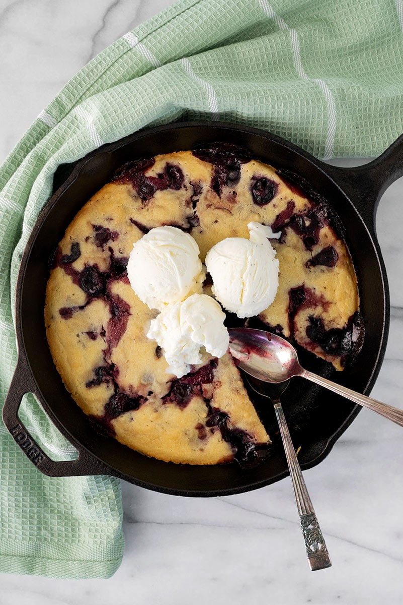 cherry cobbler with ice cream in a skillet