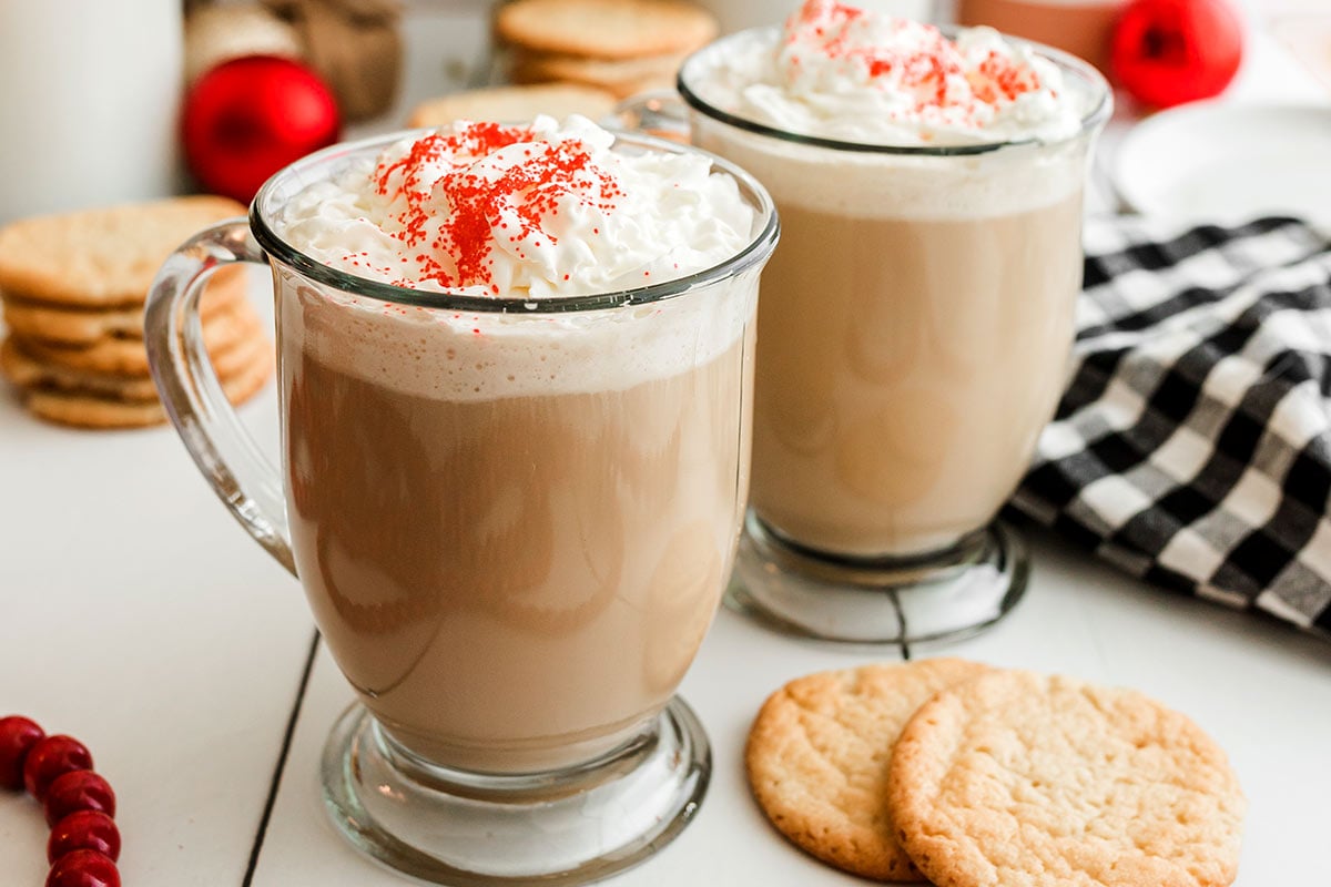 two mugs of sugar cookie lattes with whipped cream