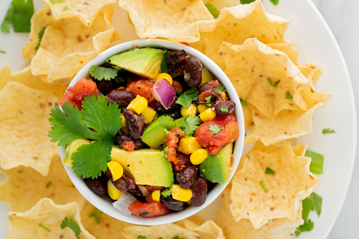 bowl of corn and black bean salsa with tortilla chips