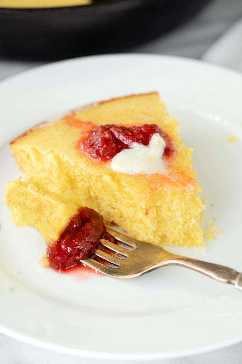 plate with a slice of buttermilk cornbread with jam