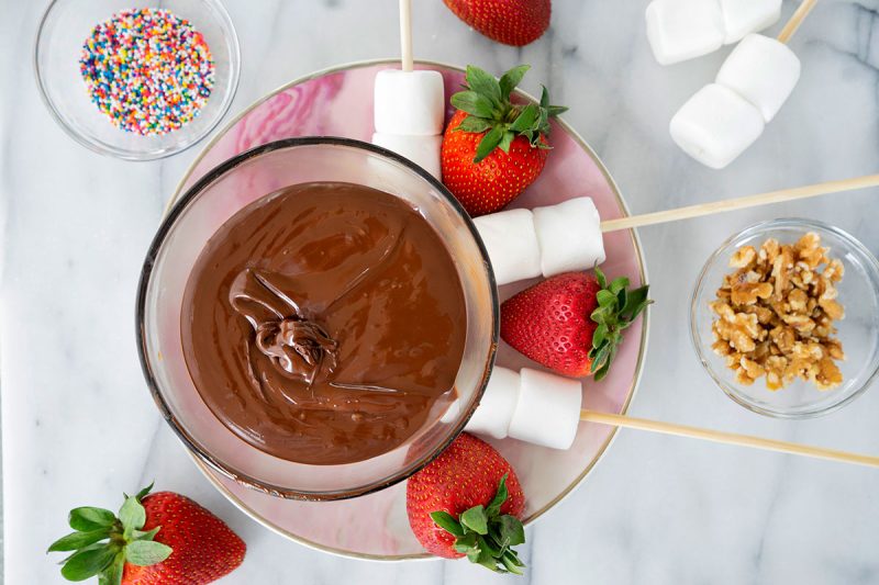 Chocolate Fondue in a bowl with marshmallows and strawberries