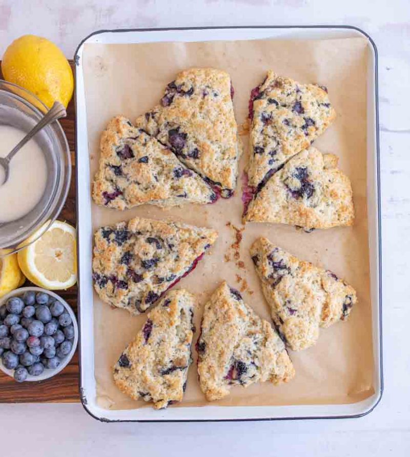 lemon blueberry scones on a parchment lined baking dish