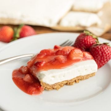 close up view of the side of a slice of no-bake strawberry cheesecake