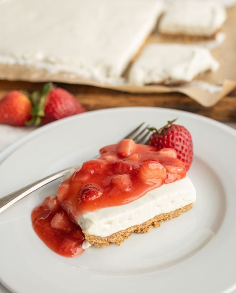 a slice of no bake strawberry shortcake with lovely chunky strawberry compote on top
