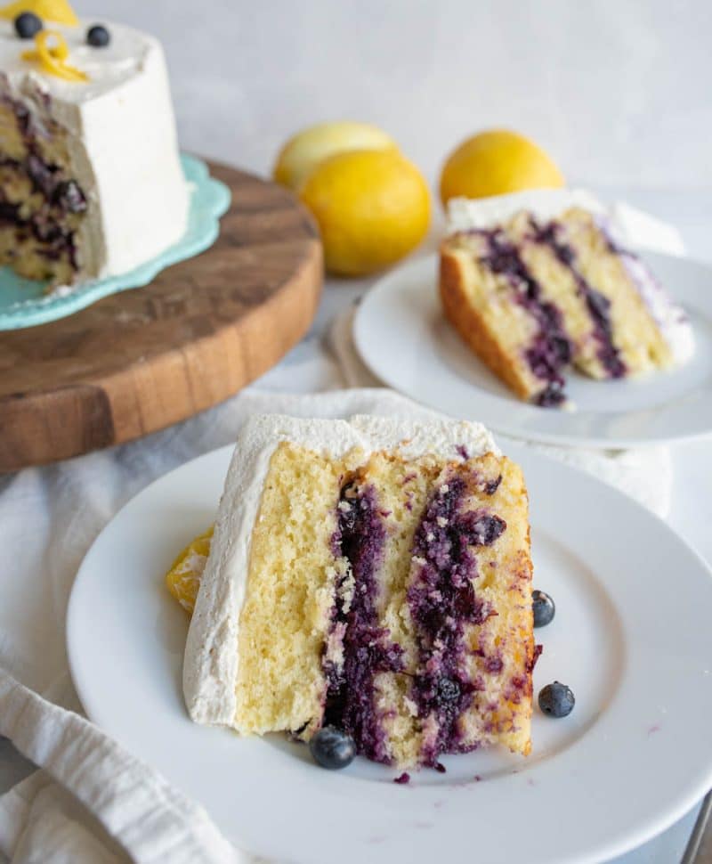 close up slice of layered lemon blueberry cake