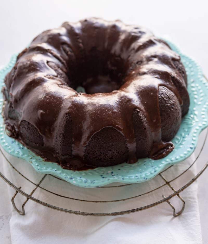 whole chocolate bundt cake with ganache chocolate sauce dripping down the sides