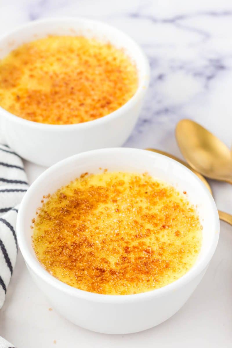 cooked creme brulle in white dish with tan sugar on top