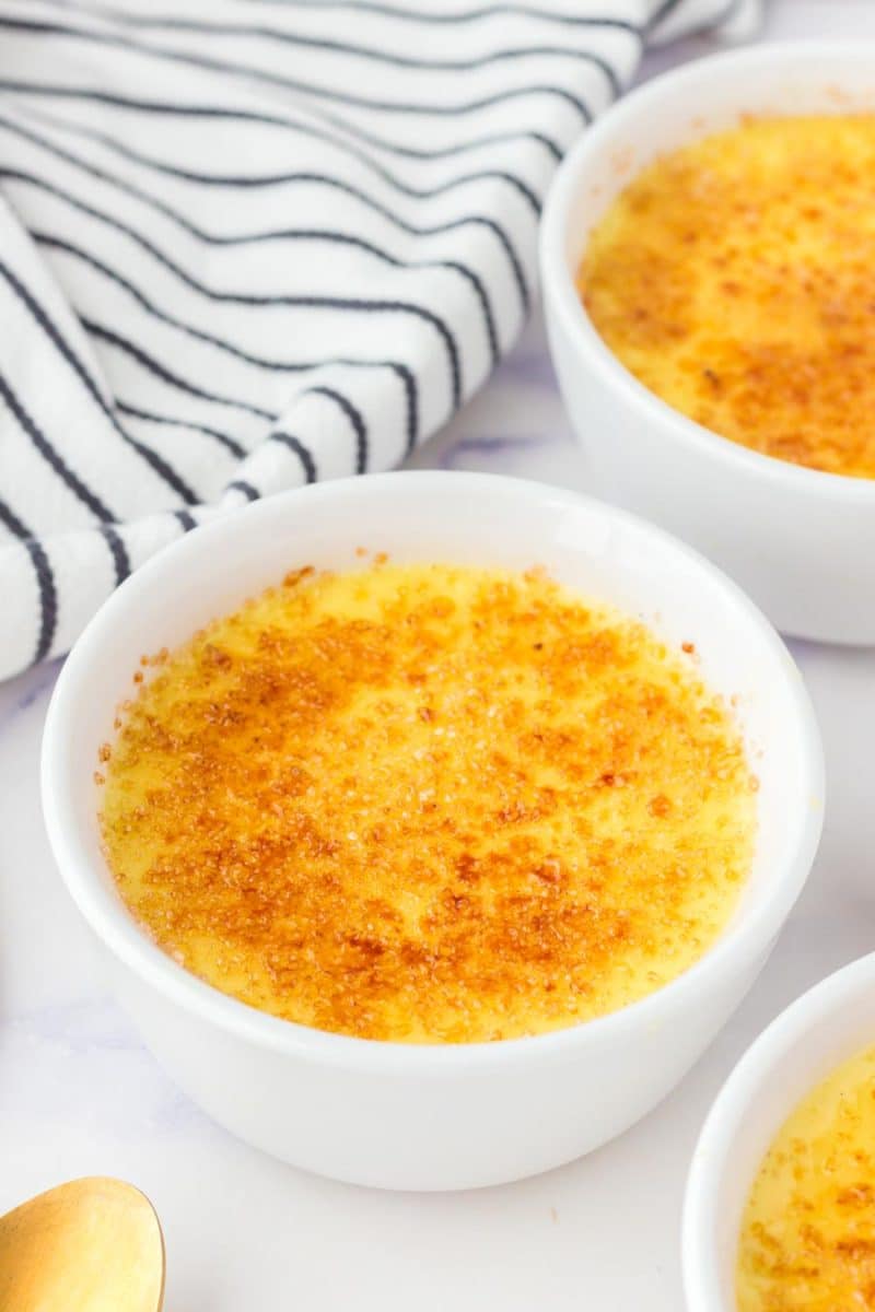 creme brulee in white dish with caramelized sugar on top