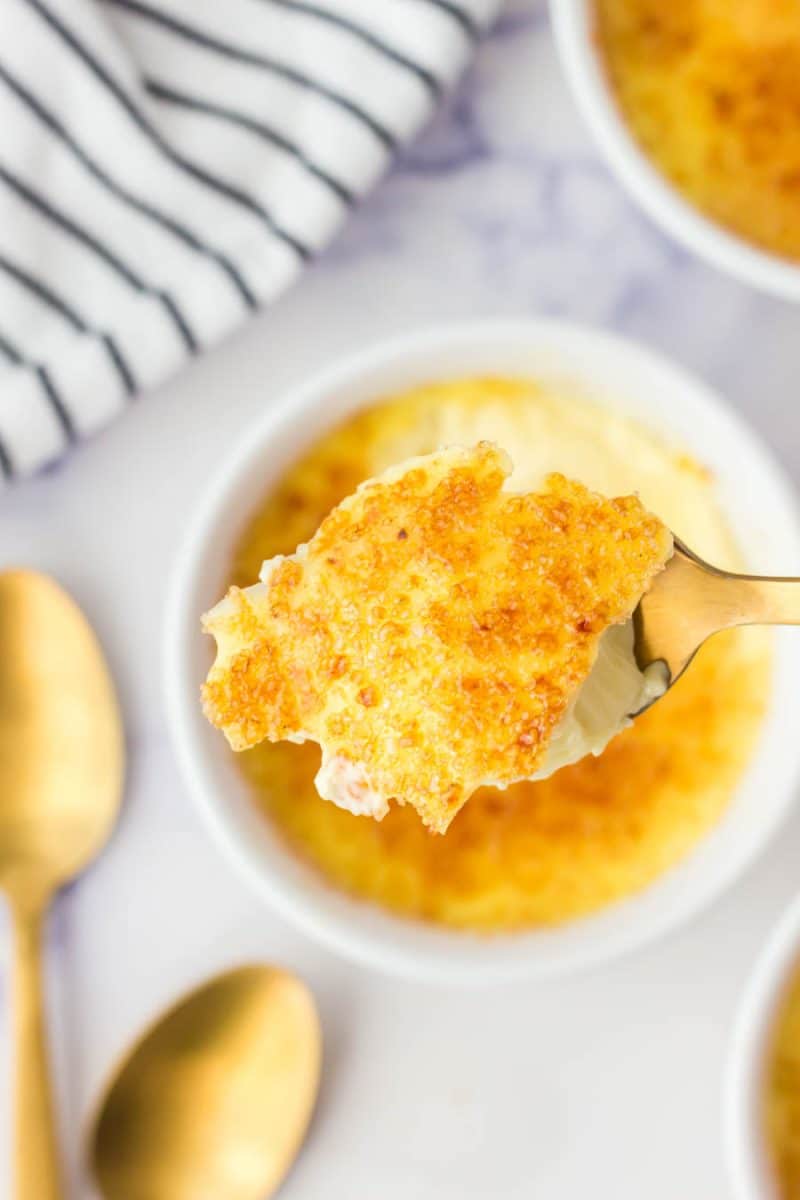 spoon holding a bit of caramelized sugar from the creme brulee