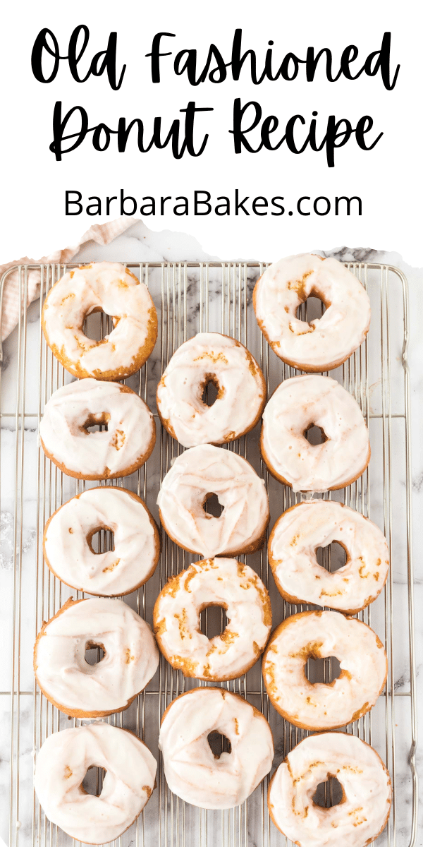 pin for old fashioned donut recipe with lots of donuts on cooling rack via @barbarabakes