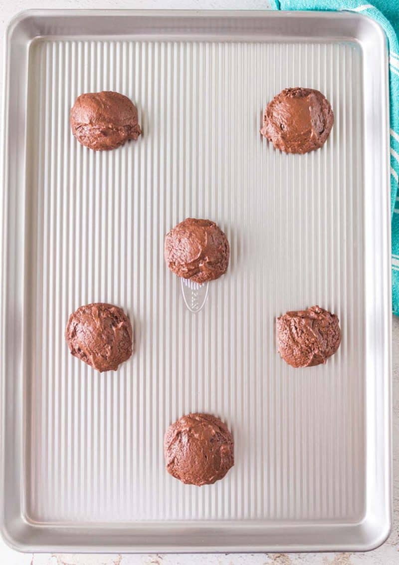 puffy double chocolate cookie dough on a cookie sheet