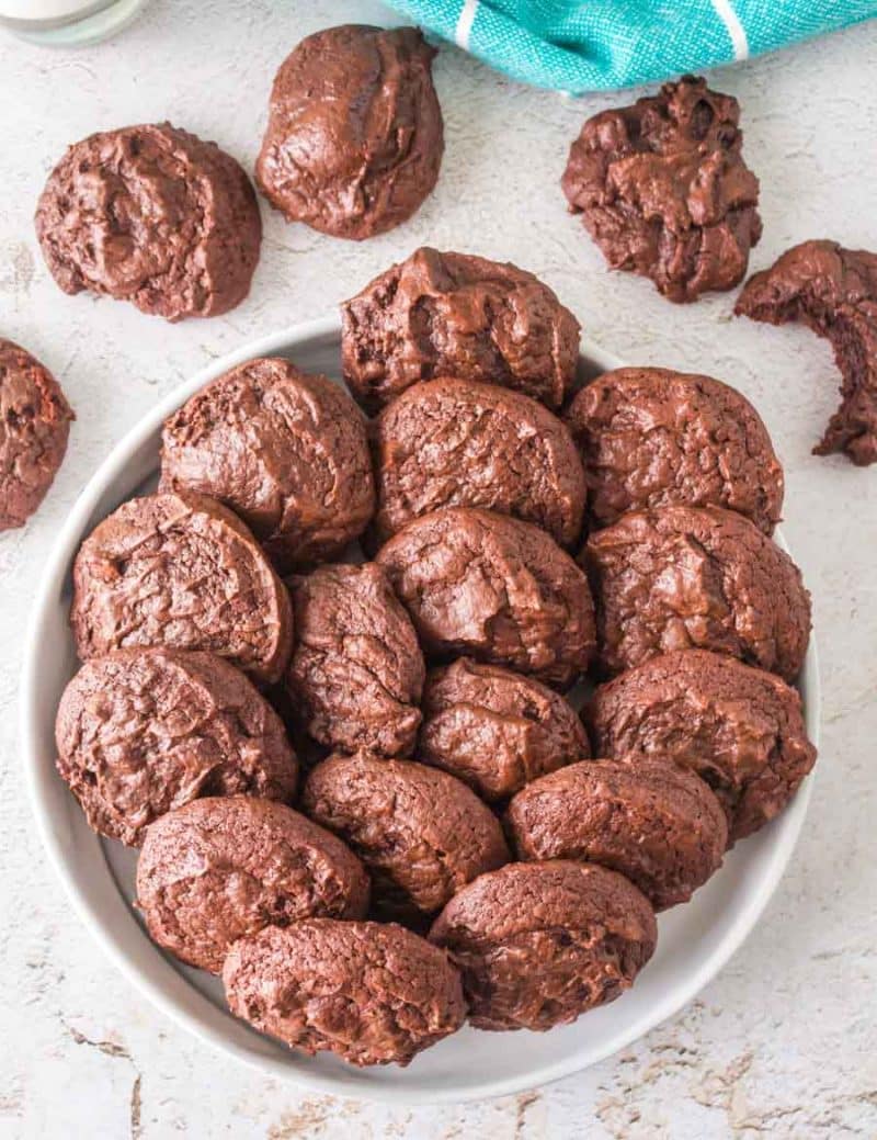 puffy double chocolate cookies stacked into a white bowl