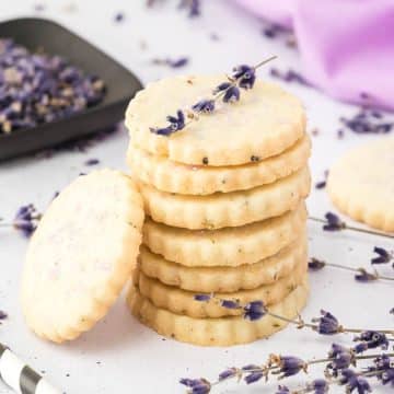 stacks of lavender shortbread cookies with sprigs of lavender