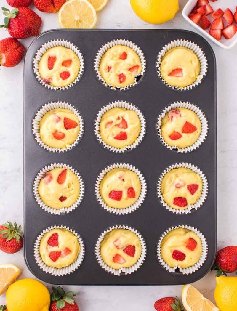 muffin tin with strawberry lemon cupcakes prepped