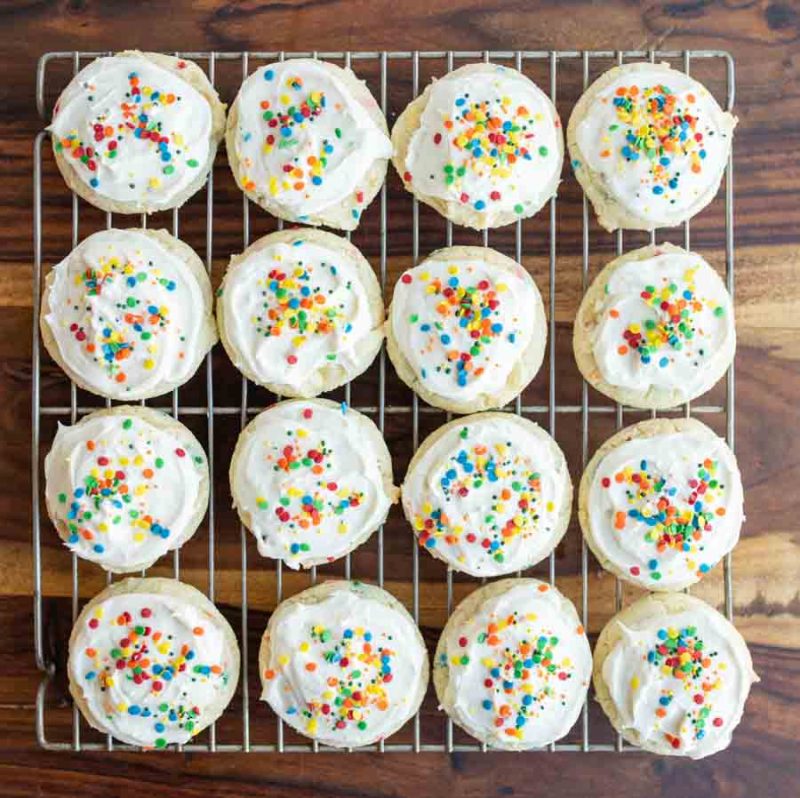 Frosted funfetti cookies on a cooling rack top view