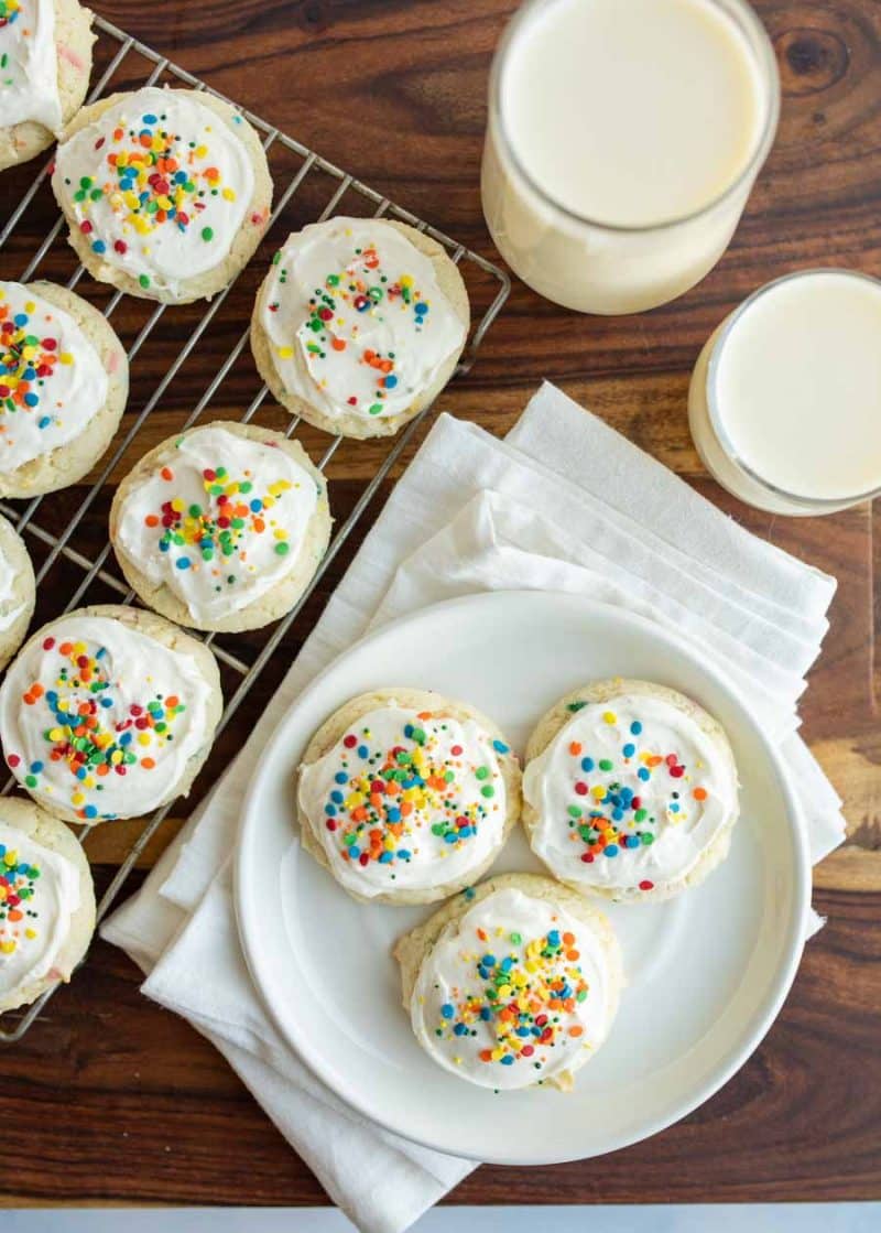 Funfetti cookies on a plate with a glass of milk next to it