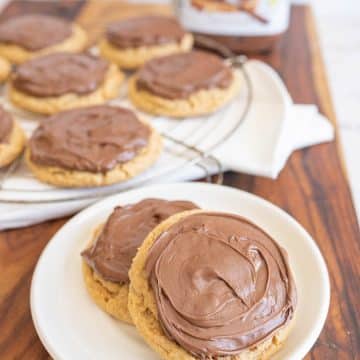 two peanut butter nutella cookies on a white plate