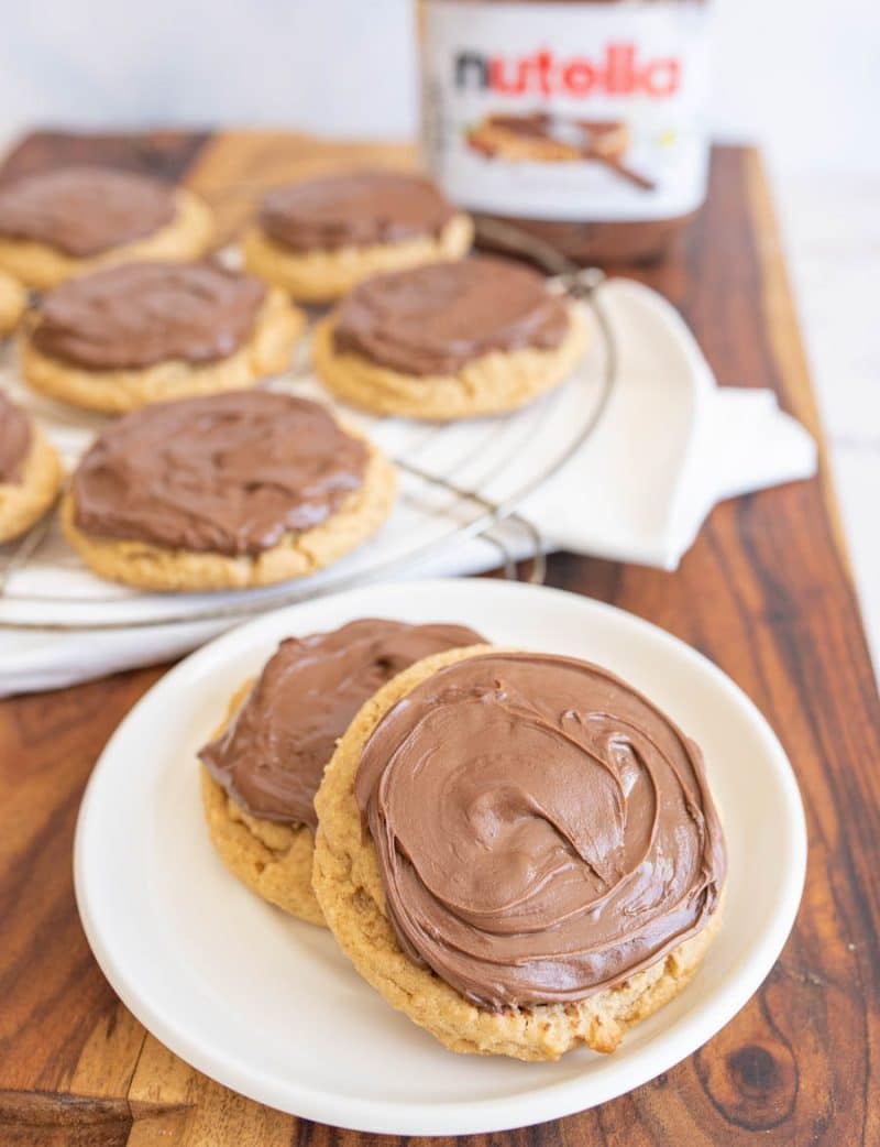 two peanut butter nutella cookies on a white plate