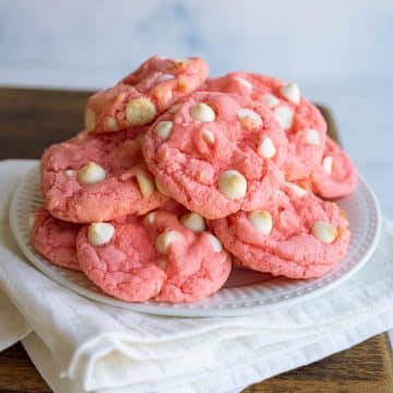 Stack of strawberry cookies on a white plate.