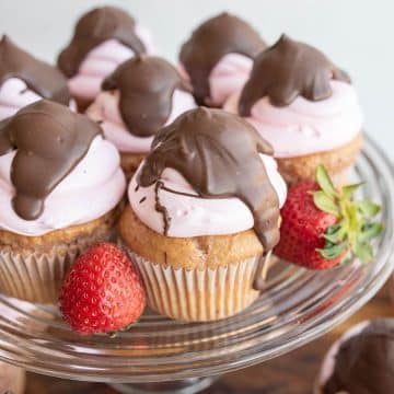 Chocolate covered strawberry cupcakes on a glass platter