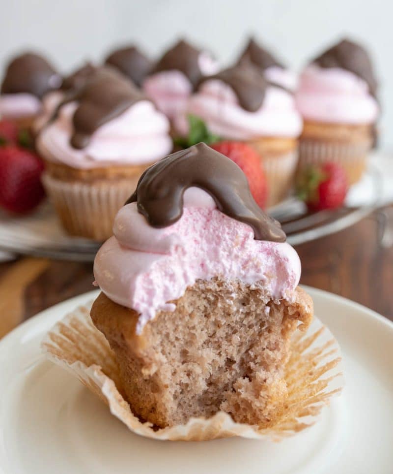close up of the inside of a chocolate strawberry covered cupcake.