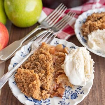 cast iron apple crumble served onto plates with ice cream