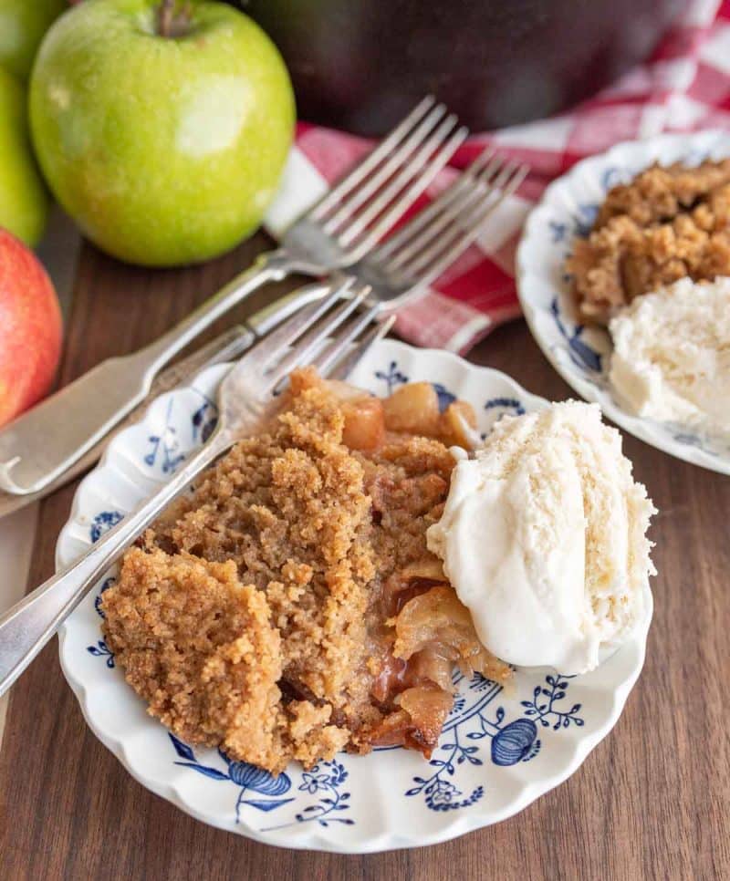 cast iron apple crumble served onto plates with ice cream