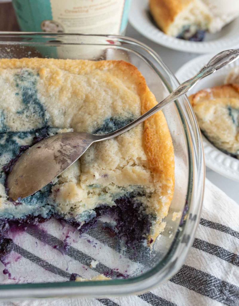 clear baking dish with blueberry cobbler