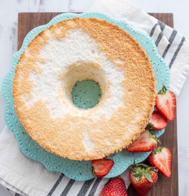 top view of a circle ring of fluffy angel food cake with strawberries around