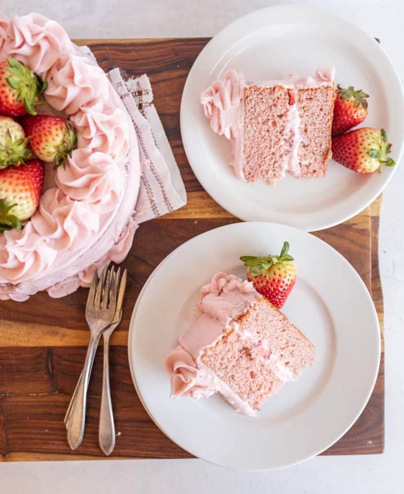top view of slices of strawberry cake with fresh strawberries on top.