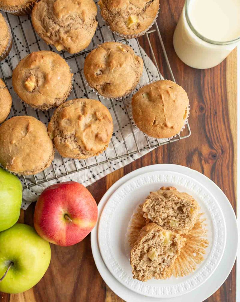 Apple cinnamon muffins with apples on display.